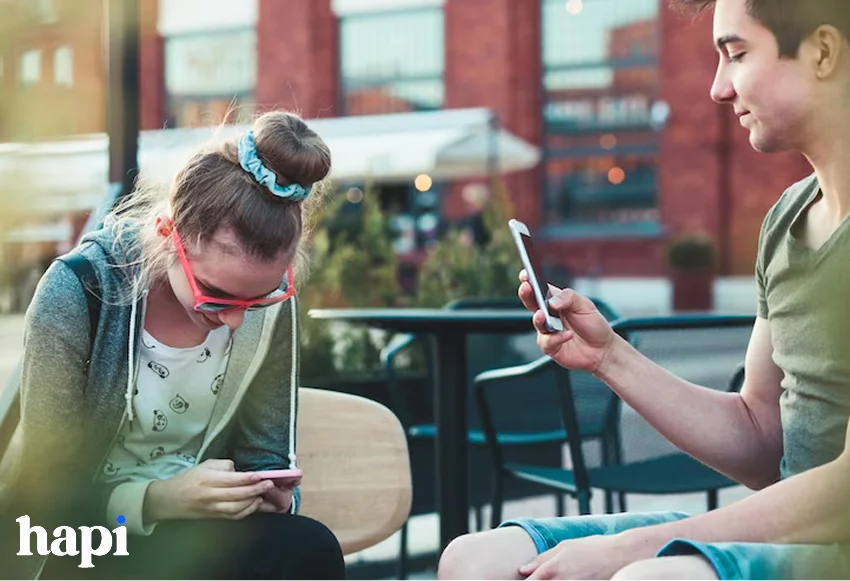 a boy and girl scrolling on social media