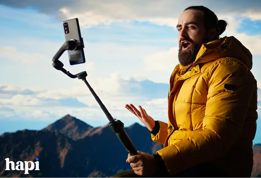 an influencer creating content at top of mountain