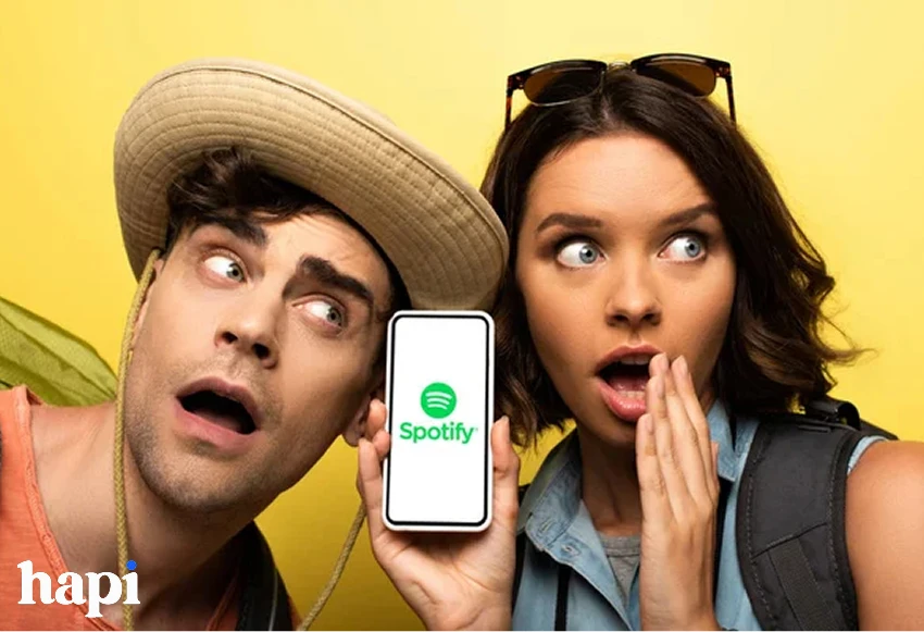a man and woman looking surprised using Spotify