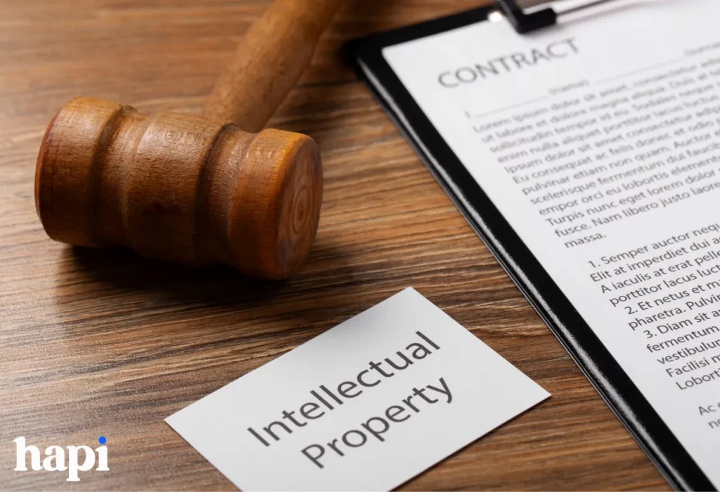 A gavel and a paper with intellectual property written on it