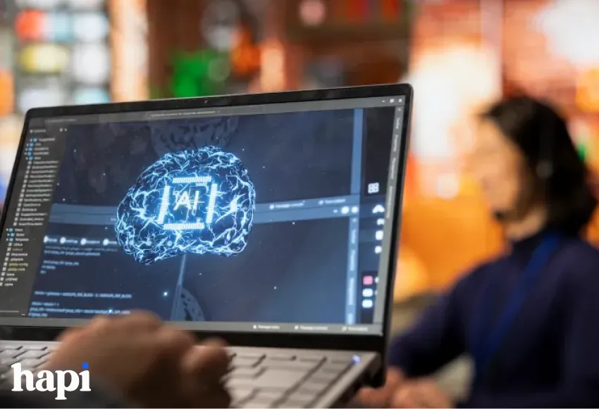 someone typing on a laptop with the word AI on the laptop