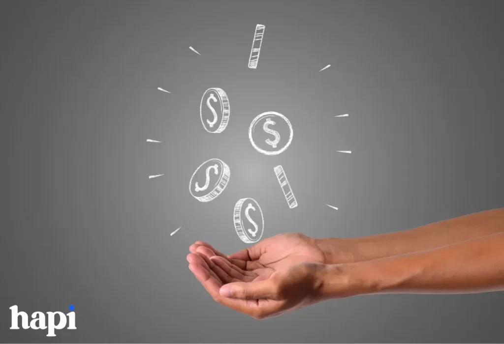 someone holding his hands and coins falling in it
