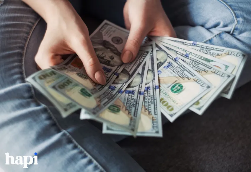 a woman with a stack of money