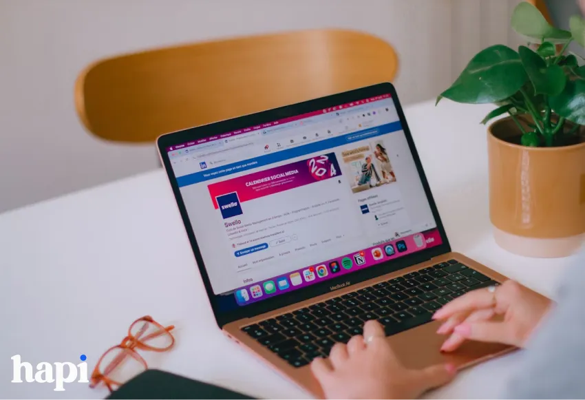 a woman working on a laptop with the LinkedIn profile open on the screen
