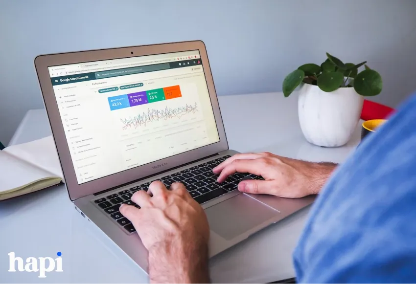a man working on a laptop with analytic data on the screen