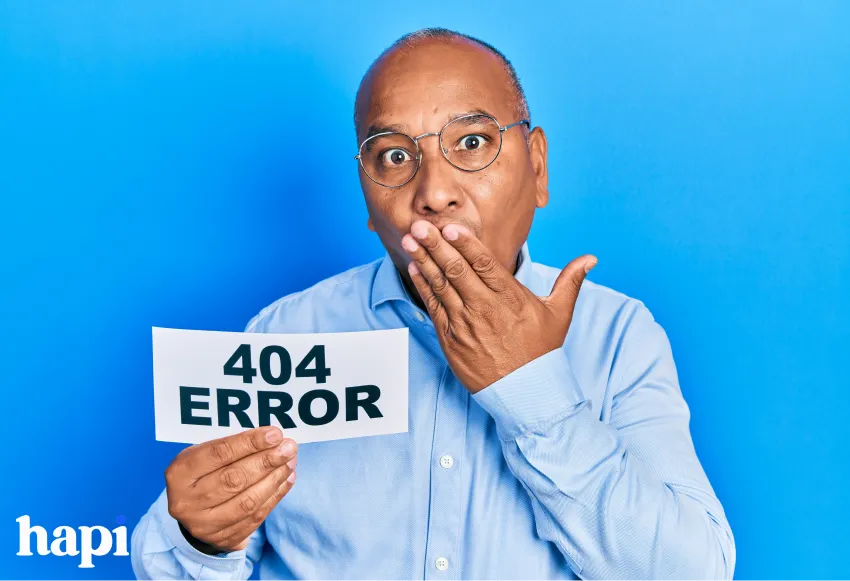 A man holding a paper with 404 Error written on it, looking confused