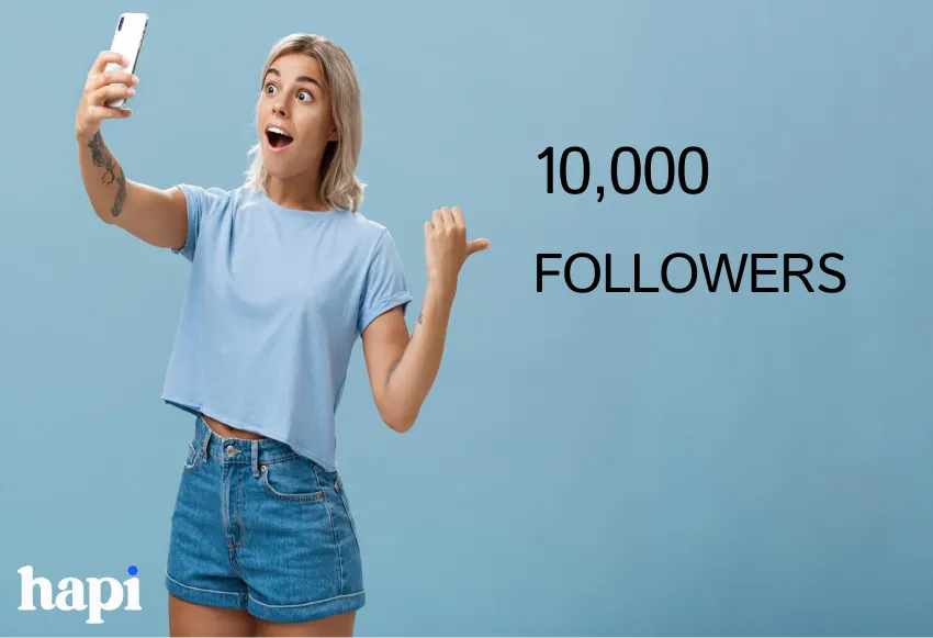 A woman taking a selfie while pointing to a text "10,000 Followers"