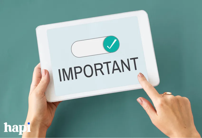 Hands holding a tablet showing the word Important