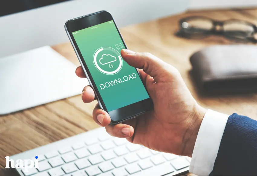 someone holding a phone with the word Download and an element of Downloading on it