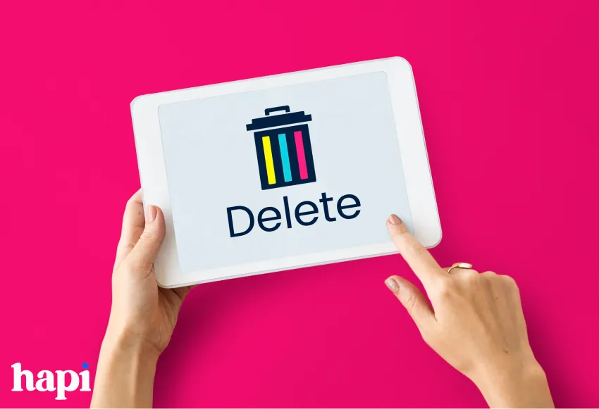 a person holding a tablet with the word Delete on it with a trashcan icon above it