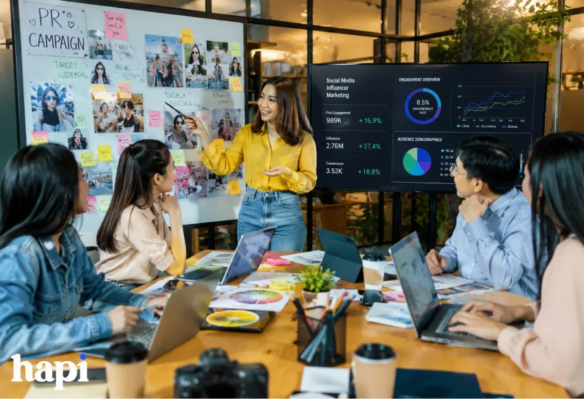 A marketing team talking about the success of their digital PR campaign